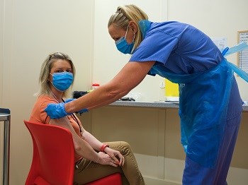 Health Visitor Suzanne Stevenson being vaccinated at the Chester Street
